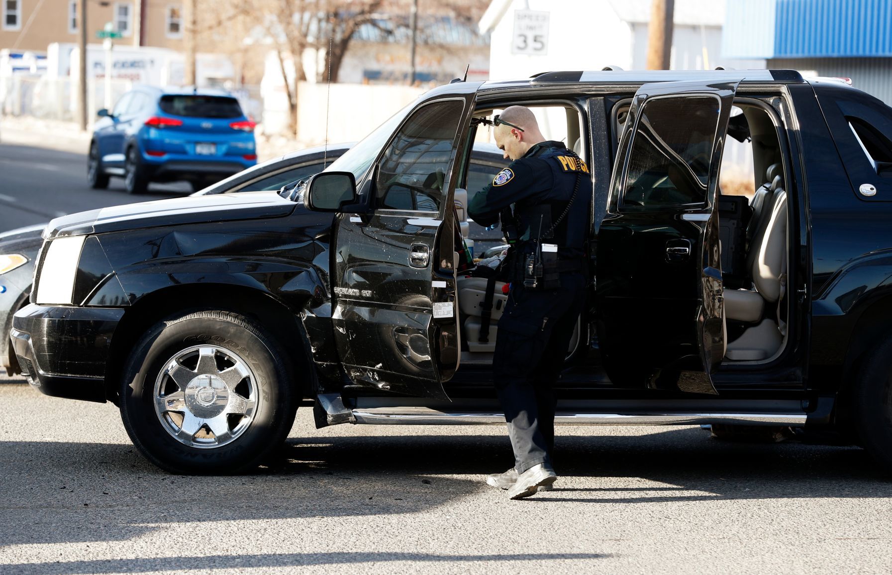 A Billings Police officer searches a Cadillac Escalade
